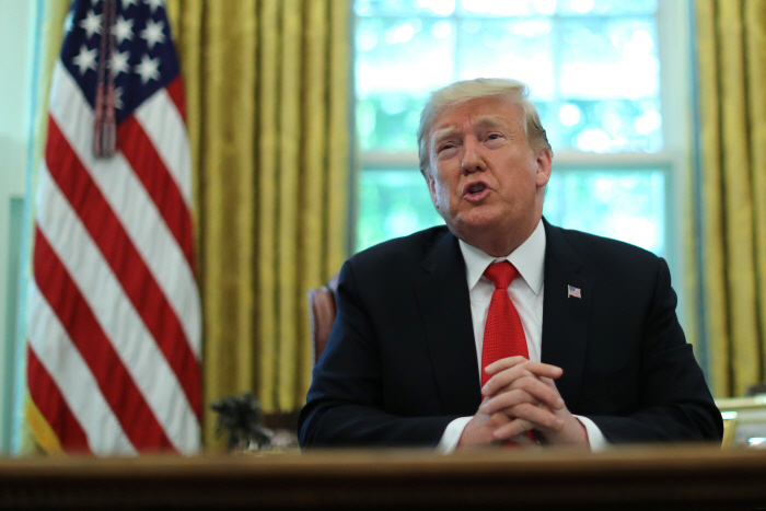 U.S. President Donald Trump speaks as he receives a status report on Hurricane Dorian in the Oval Of...